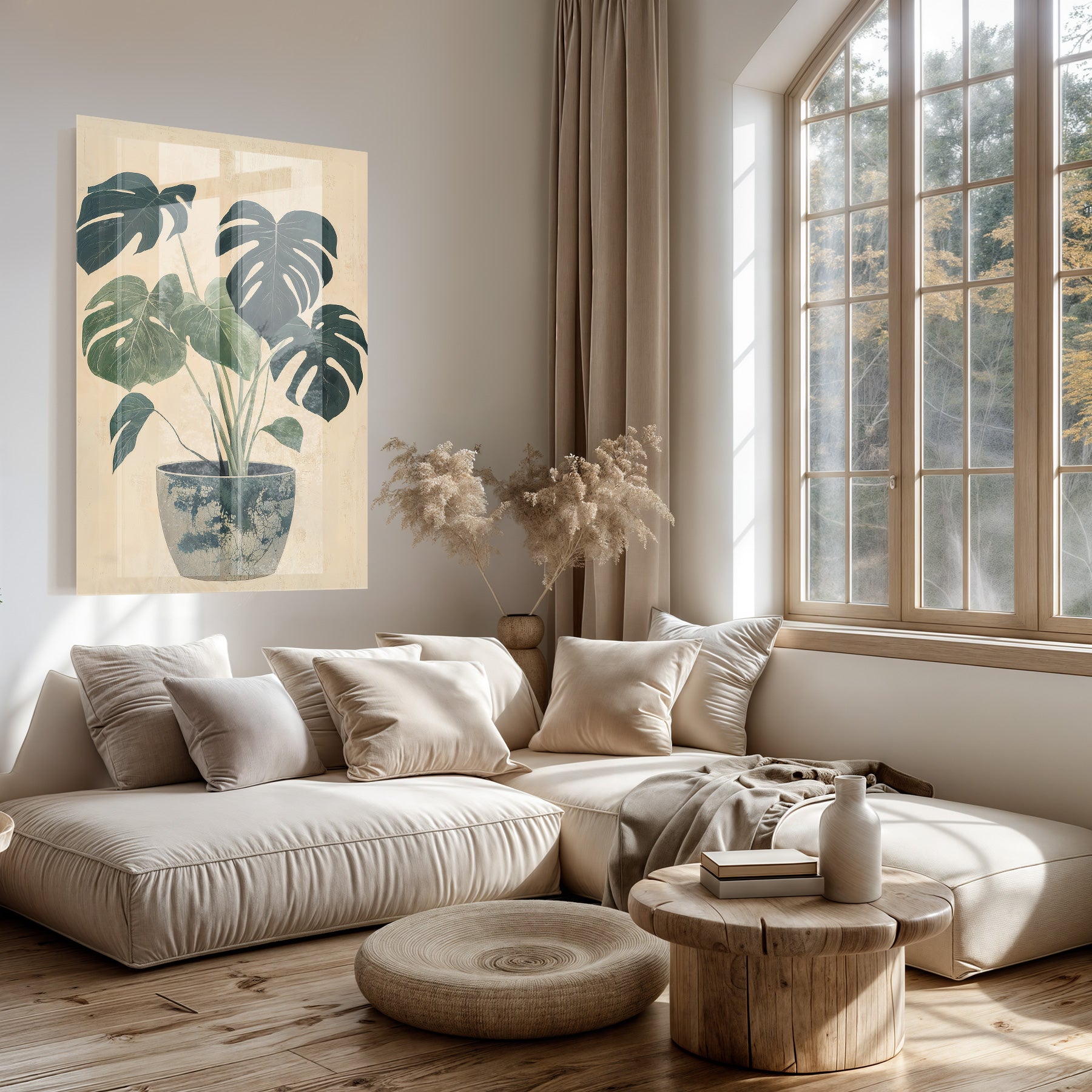 Plexiglas schilderij Monstera boven een lichte bank in een woonkamer.
