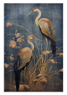 Canvas schilderij Japanse kraanvogels 3: twee langbenige vogels tussen planten tegen een blauwe achtergrond.